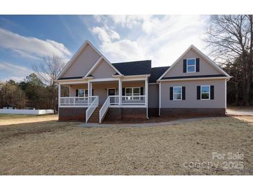 Charming home featuring a covered front porch and gray siding, located on a spacious lot at 2364 Valley Meadows Dr, York, SC 29745