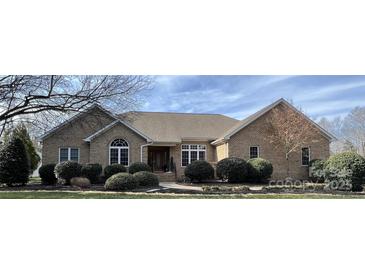 Charming brick home with well-maintained landscaping and inviting entrance, complete with a manicured front yard at 47997 Wagoner Rd, Richfield, NC 28137