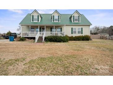 Charming two-story home with green metal roof and inviting front porch at 515 Brawley Rd, Cleveland, NC 27013