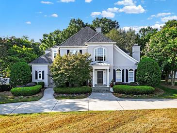 Two-story house with gray siding, gray roof, and landscaping at 10811 Old Tayport Pl, Charlotte, NC 28277