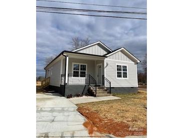 Newly constructed home with gray siding, a covered porch, and a landscaped yard at 1526 W Horah St, Salisbury, NC 28144