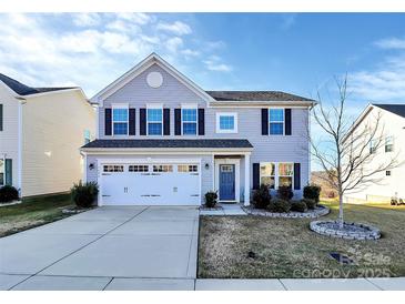 Charming two-story home with a well-manicured lawn and a two-car garage at 1686 Scarbrough Sw Cir, Concord, NC 28025