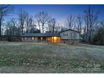 Brick ranch home with covered porch, nestled on a spacious lot with mature trees at 178 Brady Circle Rd, Statesville, NC 28625