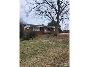 Charming single-story brick home with well-maintained lawn and mature trees at 32269 Pennington Rd, Albemarle, NC 28001