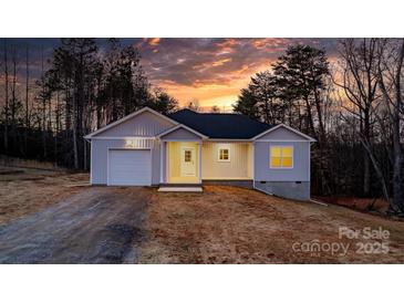 Charming single-story home featuring attached garage and covered porch, set against a colorful sunset backdrop at 3722 Thompson St, Newton, NC 28658
