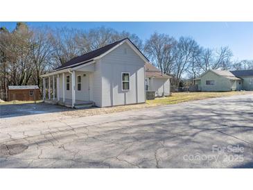 Cozy home showcasing a charming front porch with a fresh coat of light-gray paint at 528 6Th St, Chester, SC 29706