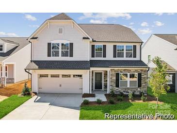 Charming two-story home featuring a two-car garage, stone accents, and a well-manicured lawn at 112 Stonewater Dr # 33P, Red Cross, NC 28129