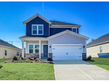 Two-story home showcasing a two-car garage, blue and grey siding, and a well-manicured lawn at 139 Aberdeen Dr, Salisbury, NC 28144