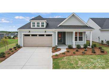 Charming single-Gathering home featuring a two-car garage, manicured lawn, and inviting front porch at 1726 Riverbend Ave # 177, Belmont, NC 28012
