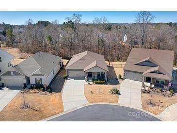 Aerial view of a neighborhood showcasing well-maintained homes, driveways, and mature trees at 1903 Lotus Ln, Denver, NC 28037