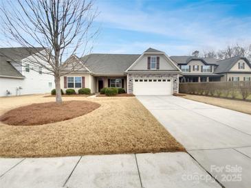 Charming single-story home featuring manicured lawn, neutral siding, and an attached two-car garage at 1805 Palazzo Dr, Waxhaw, NC 28173