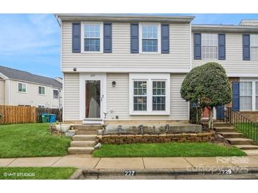 Charming townhome exterior with blue shutters, tidy landscaping, and visible address number at 227 Water Oak Dr, Pineville, NC 28134