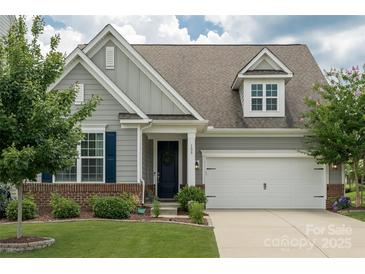 Charming home featuring a well-manicured lawn, inviting front porch, and a two-car garage at 108 Hillston Ln, Mooresville, NC 28115