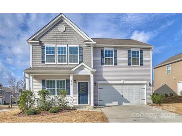 Charming two-story home features a covered entryway, light gray siding, and an attached two-car garage at 4010 Richard Andrew Dr, Matthews, NC 28105