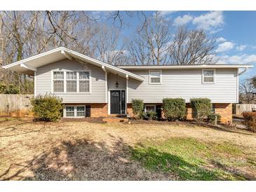 Charming split-level home featuring light gray siding, an A-frame roof, and a well-maintained front yard at 4000 Elizabeth St, Hickory, NC 28601
