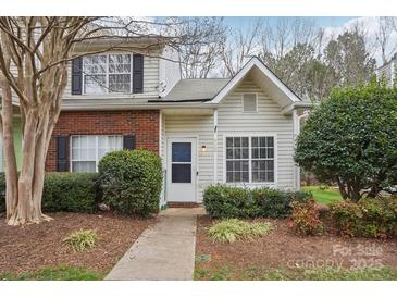 Charming two-story townhome featuring brick accents, vinyl siding, and mature landscaping at 9160 Exbury Ct, Charlotte, NC 28269