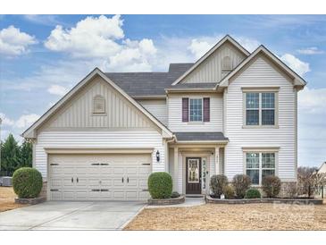 Charming two-story home featuring a two-car garage and beautifully landscaped front yard at 1035 Ivey Ct, Fort Mill, SC 29707