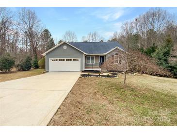 Charming home featuring a combination of stone and vinyl siding, complemented by an attached two-car garage and a well-manicured lawn at 121 Purple Finch Ln, Mooresville, NC 28117