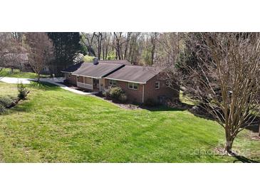Lovely brick ranch-style home with lush green lawn and inviting front porch at 2360 Kings Grant Rd, Lincolnton, NC 28092