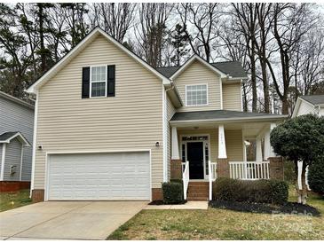 Charming two-story home with a well-maintained lawn, attached garage, and welcoming front porch at 4809 Canipe Dr, Charlotte, NC 28269