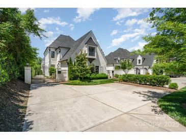 Stunning two-story home with a gated driveway and manicured landscaping, offering both privacy and curb appeal at 1328 S Kings Dr, Charlotte, NC 28207