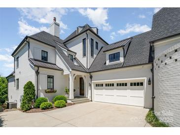 Beautiful traditional home featuring a large garage, manicured landscaping, and a modern architectural design at 1328 S Kings Dr, Charlotte, NC 28207