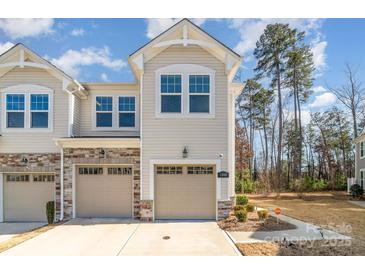 Charming townhome featuring a two-car garage and manicured landscaping at 1348 Southern Sugar Dr, Charlotte, NC 28262