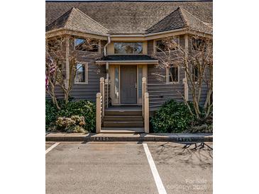 Charming condo with a gray front entrance with well-maintained landscaping at 14106 Yachtsman Harbor Dr, Charlotte, NC 28278