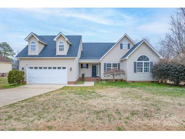 Charming two-story home with a well-manicured lawn and attached two-car garage at 1750 Williamsburg Dr, Rock Hill, SC 29732