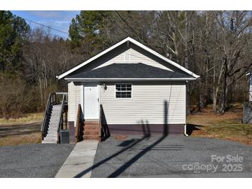 A charming, compact single-story home with a fresh exterior and a welcoming entrance at 206 Lincoln St, Badin, NC 28001