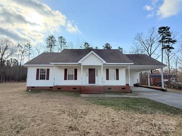 Charming single-story home with a large covered carport and well-maintained front yard, perfect for suburban living at 2070 Hunters Ridge Rd, Lancaster, SC 29720