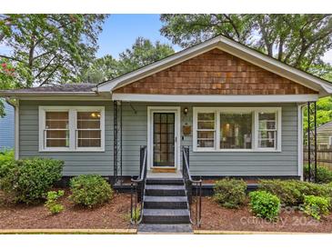 Inviting craftsman-style home with a cozy front porch and manicured landscaping at 2115 Laburnum Ave, Charlotte, NC 28205