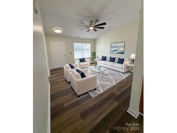 Bright living room with vaulted ceiling, modern furnishings and wood-look flooring at 2307 Hope Valley Ln, Charlotte, NC 28213
