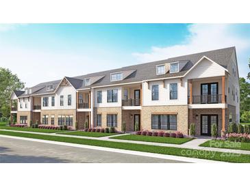 Charming brick and siding townhome complex with well-manicured landscaping and covered entrance at 3100 Endhaven Terraces Ln # 9, Charlotte, NC 28277
