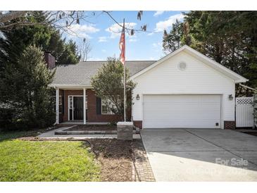 Charming single-story home with a brick facade, attached two-car garage, and mature trees at 3507 Selway Dr # 14, Indian Trail, NC 28079