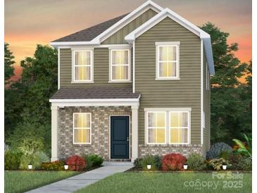 Charming two-story home with a brick and vinyl facade, complemented by a well-manicured front yard at 14036 Penbury Ln # 333, Charlotte, NC 28278