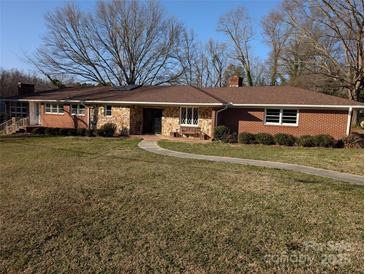 Charming single-story brick home with manicured lawn and stone accents at 1807 Brantley Rd, Kannapolis, NC 28083