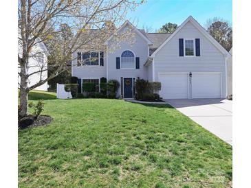 Charming two-story home boasts a manicured lawn, attached two car garage, and inviting curb appeal at 2043 Covered Bridge Ct, Rock Hill, SC 29732