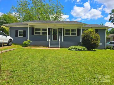 Charming home featuring well-maintained landscaping, a covered porch, and a classic design at 4930 Crestmont Dr, Charlotte, NC 28205