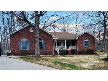 Charming brick home featuring blue shutters and a cozy front porch at 920 Hunting Ave, Lincolnton, NC 28092