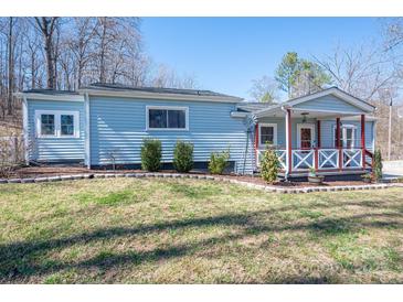 Charming blue home with a lovely front porch and well-maintained lawn at 939 Dameron Rd, Bessemer City, NC 28016