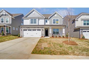 Charming two-story home with stone accents and well-manicured lawn, creating a welcoming curb appeal at 108 Ellsworth Rd # 40, Mooresville, NC 28115