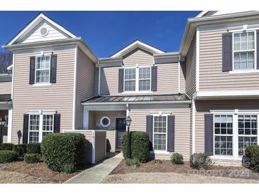 Inviting two-story townhome with neutral siding, dark shutters, and well-maintained landscaping at 14713 Lions Pride Ct, Charlotte, NC 28273