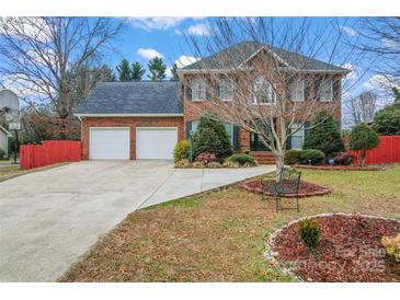 Charming two-story brick home features a two-car garage and a beautifully landscaped front yard at 1511 35Th Ne Ave, Hickory, NC 28601