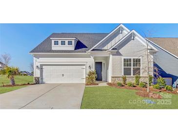Charming home with a white garage, stone accents, black front door, and a well-manicured lawn at 19007 Dry Narrows Way, Charlotte, NC 28278