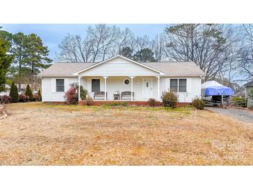 Charming one story home featuring a cozy front porch and well-maintained landscaping on a spacious lot at 431 Island Cove Rd # 86, Norwood, NC 28128