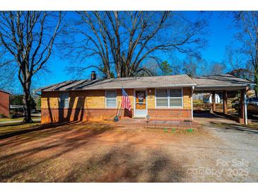 Charming brick ranch home with a covered carport and an American flag out front at 510 W 15Th St, Newton, NC 28658