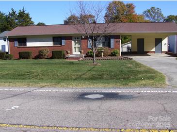 Charming single-story home with brick facade, manicured lawn, and convenient carport at 6434 Miller Rd, Kannapolis, NC 28081
