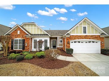 Charming one-story home with brick and siding exterior, landscaped yard, and attached two-car garage at 7203 Shenandoah Dr, Fort Mill, SC 29707