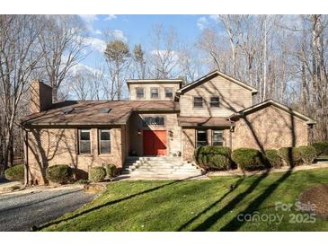 Charming two-story home with a well-manicured lawn and brick accents at 1006 Lost Cv, Weddington, NC 28104